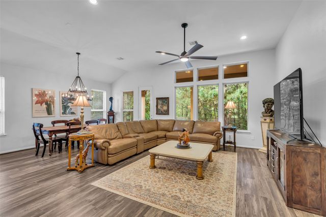 a living room with furniture a window and gym equipment