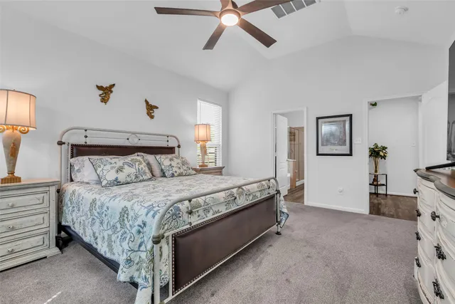a bedroom with a bed and ceiling fan