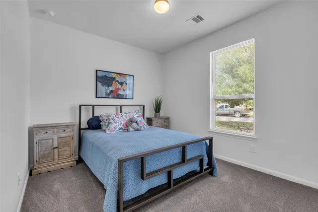 a bedroom with a bed and a window