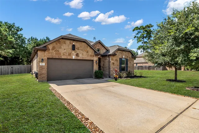 a front view of a house with a yard and garage