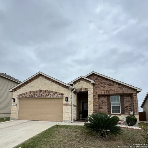 a view of a house with a garage and a yard