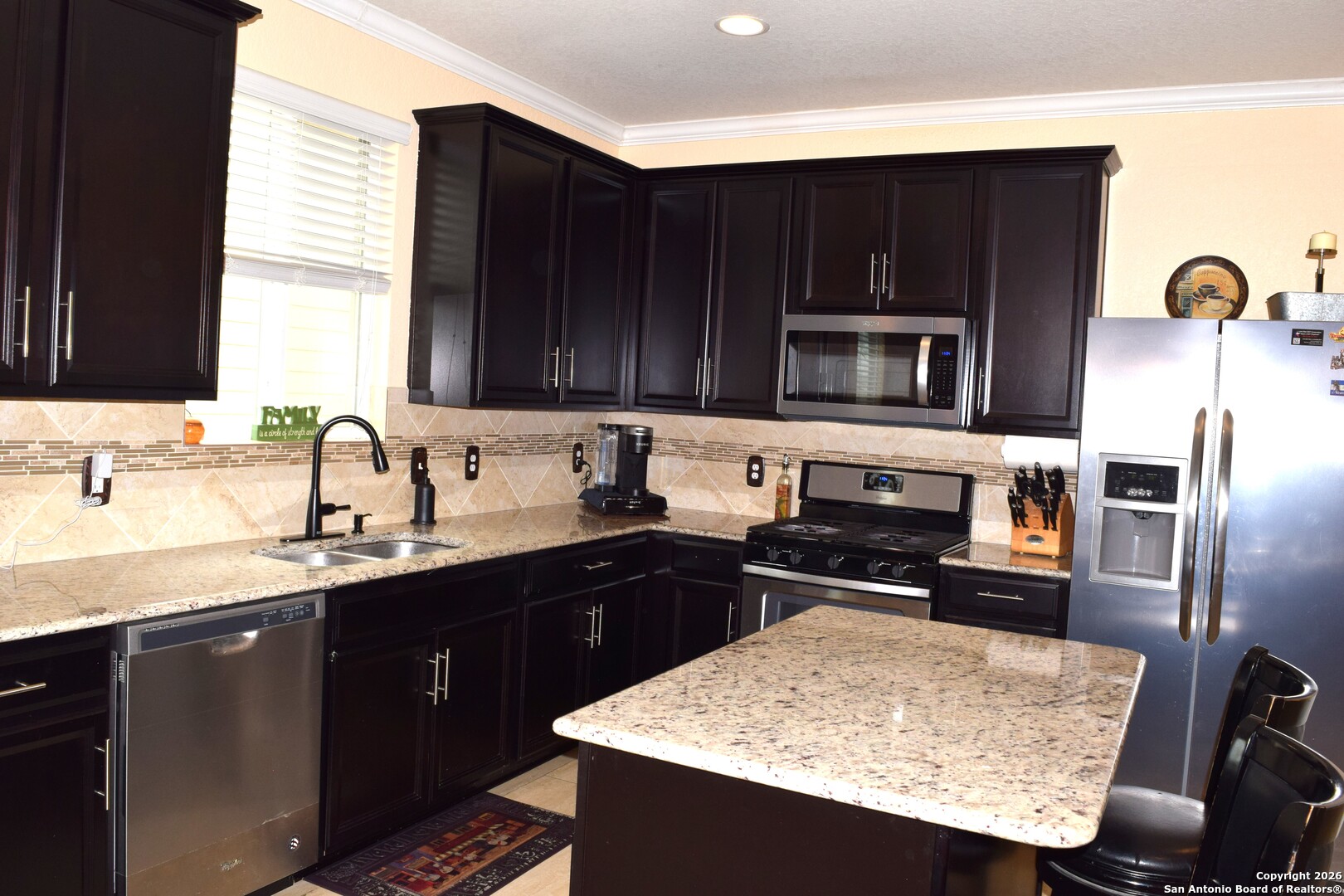 7215 Capricorn Way Converse, TX 78109 - Photo 8 of 22 a kitchen with granite countertop a sink stainless steel appliances and cabinets