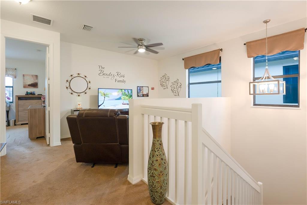 5092 Beckton Road Ave Maria, FL 34142 - Photo 18 of 36 a living room with furniture and a chandelier