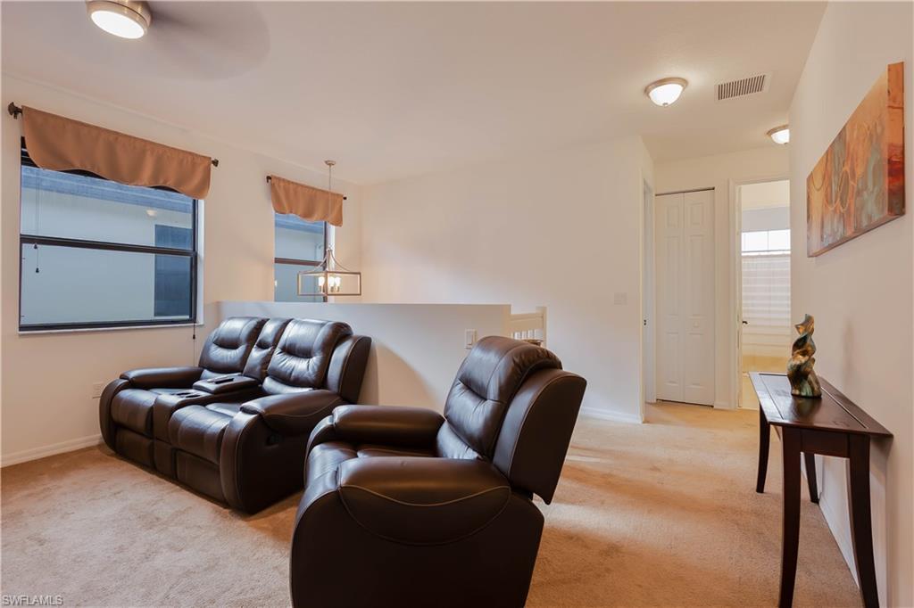 5092 Beckton Road Ave Maria, FL 34142 - Photo 20 of 36 a living room with furniture and a lamp