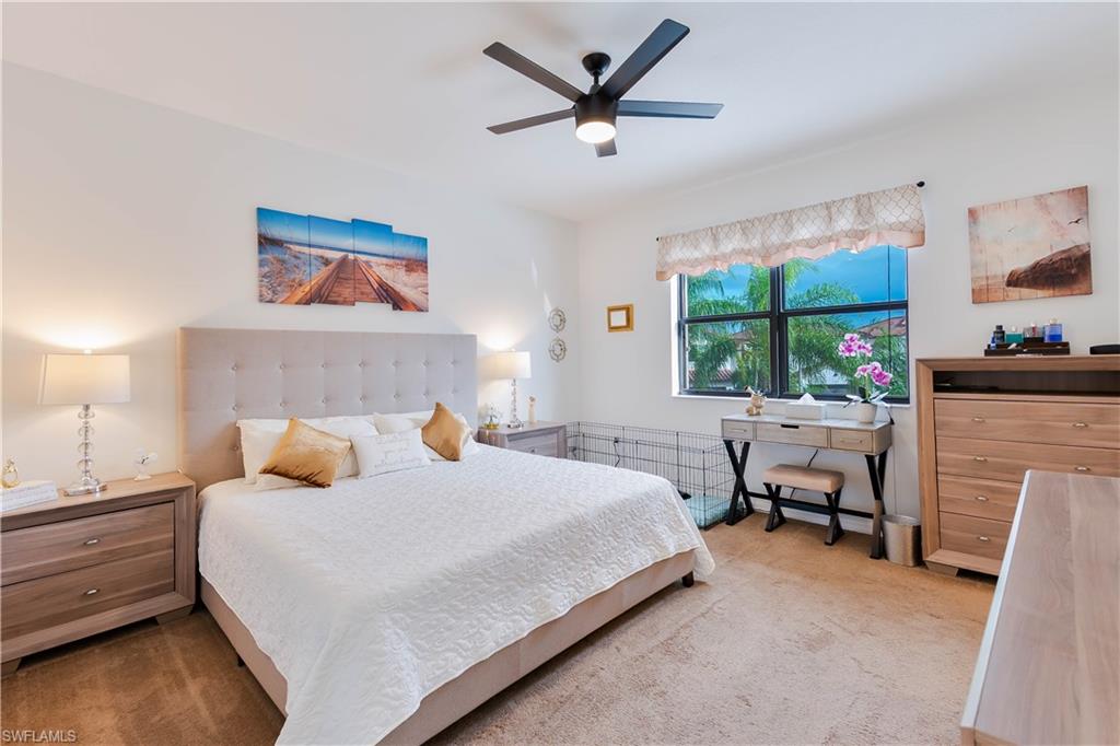 5092 Beckton Road Ave Maria, FL 34142 - Photo 21 of 36 a bedroom with a bed a couch and a window