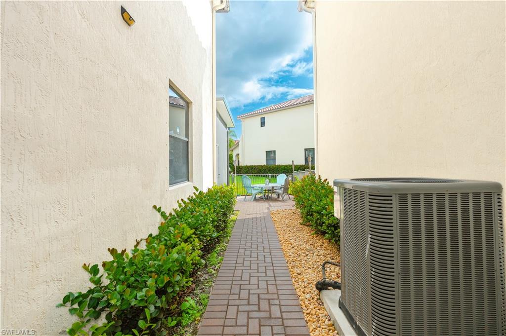 5092 Beckton Road Ave Maria, FL 34142 - Photo 29 of 36 a view of a pathway with a flower plants