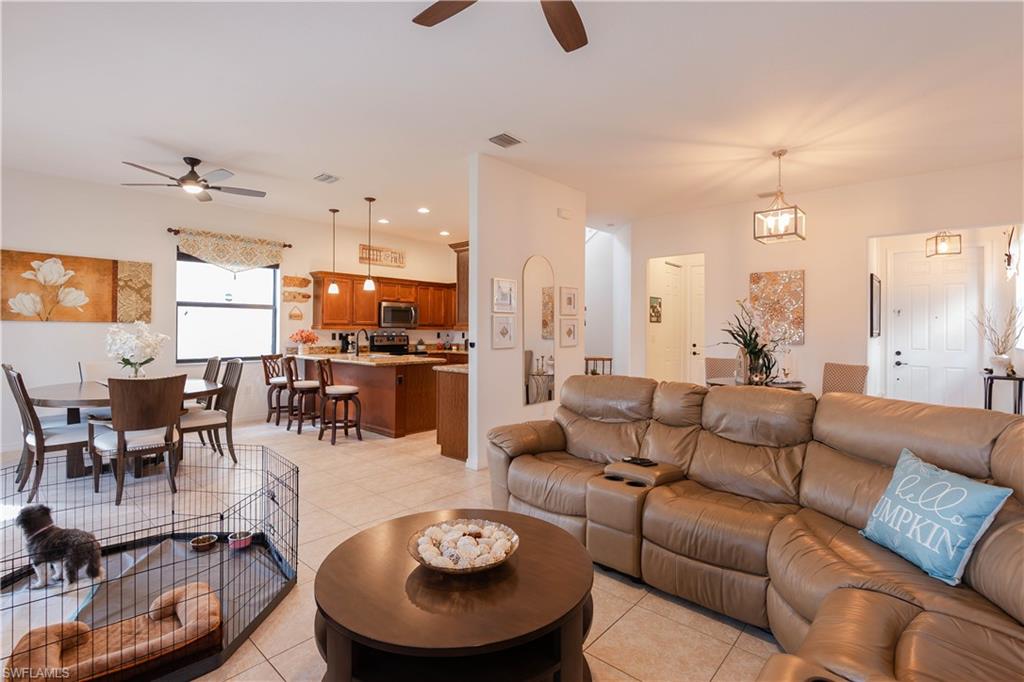 5092 Beckton Road Ave Maria, FL 34142 - Photo 4 of 36 a living room with furniture kitchen view and a chandelier