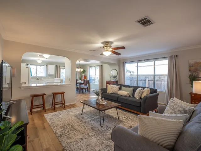 a living room with furniture and a large window