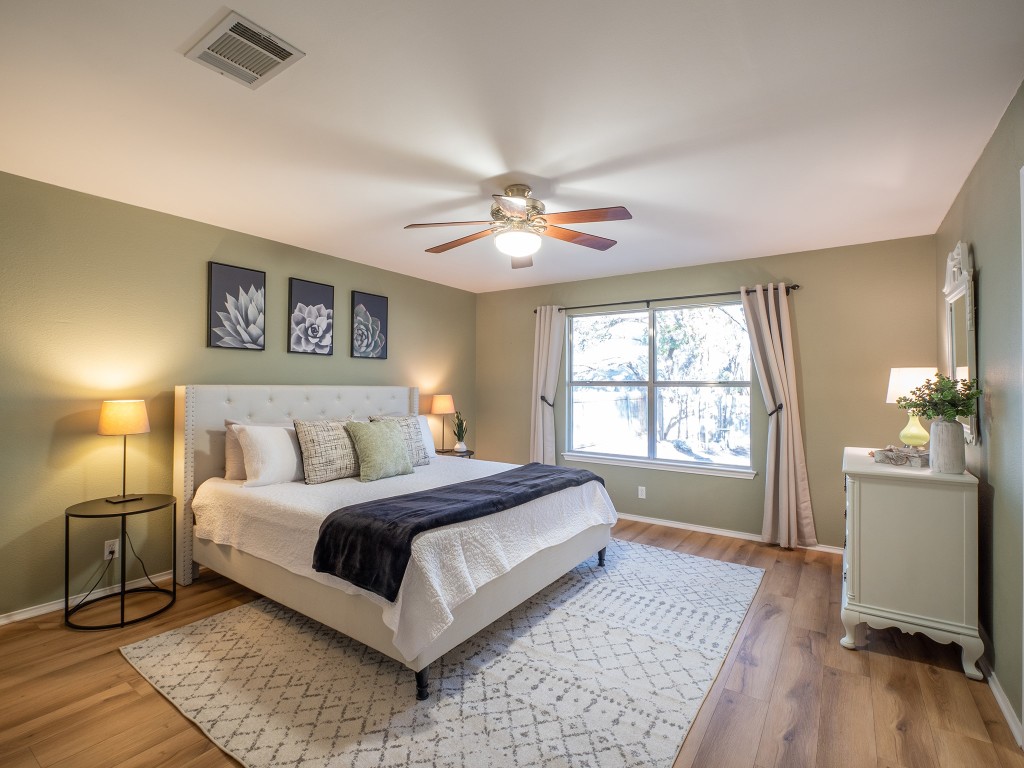 9610 Dalewood Drive Austin, TX 78729 - Photo 14 of 27 a spacious bedroom with a large bed and a window