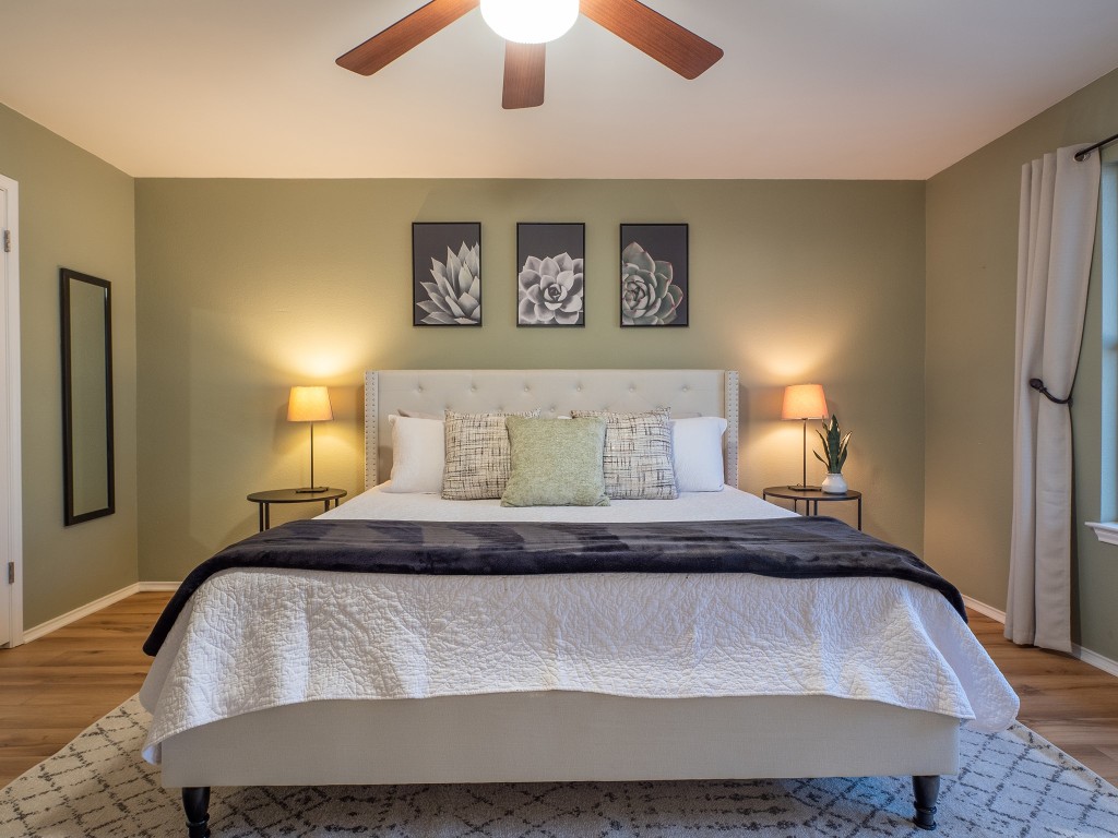 9610 Dalewood Drive Austin, TX 78729 - Photo 15 of 27 a bedroom with a bed and a night stand