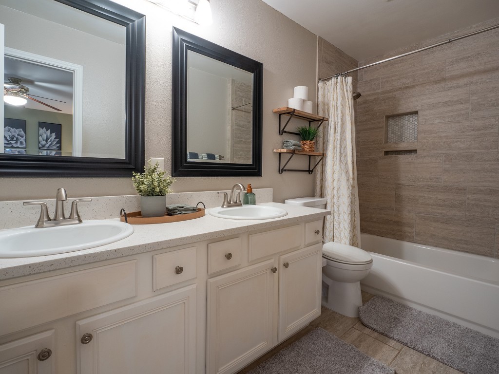 9610 Dalewood Drive Austin, TX 78729 - Photo 16 of 27 a bathroom with a double vanity sink mirror double and bathtub