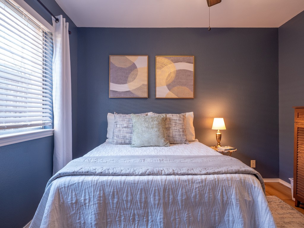 9610 Dalewood Drive Austin, TX 78729 - Photo 18 of 27 a bedroom with a bed and window