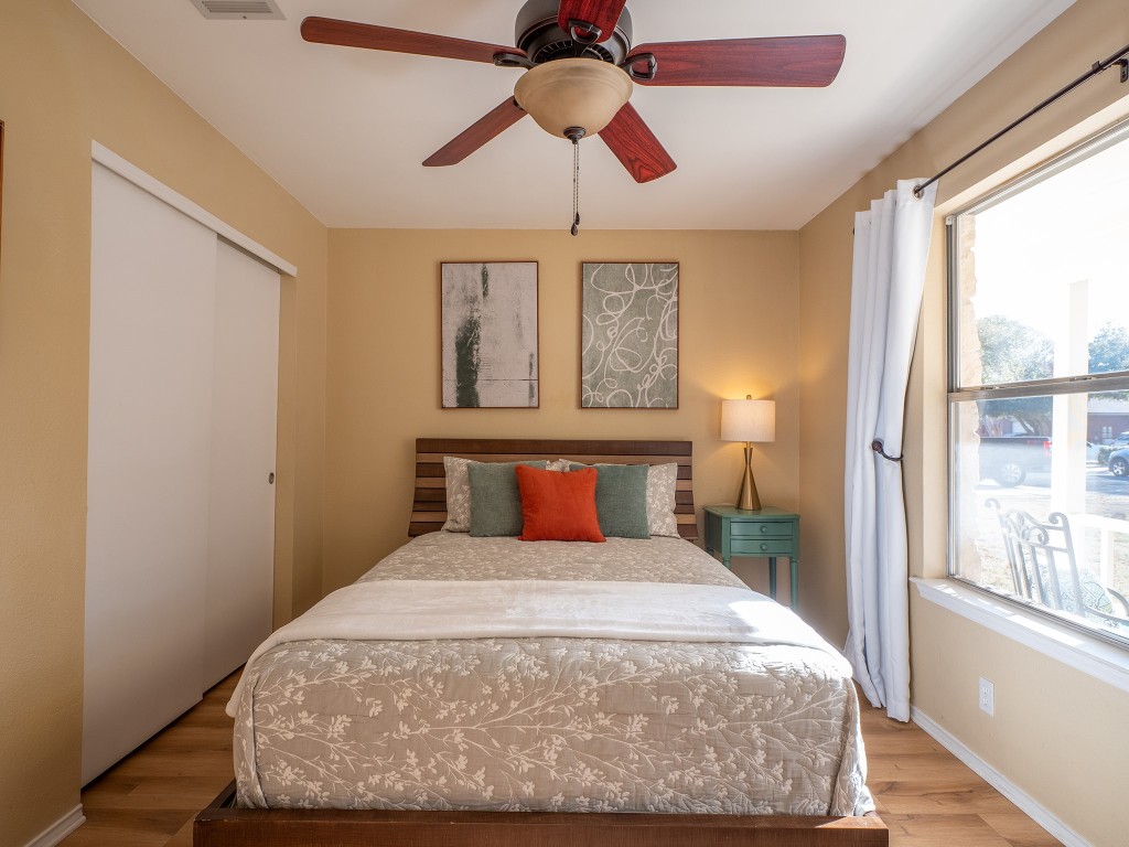 9610 Dalewood Drive Austin, TX 78729 - Photo 21 of 27 a bedroom with a bed and window