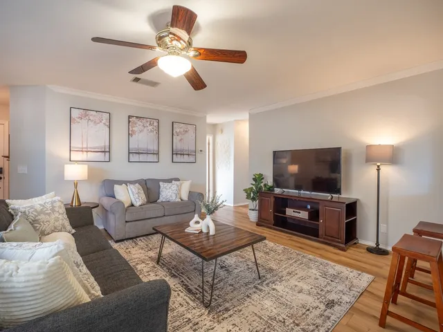 a living room with furniture and a flat screen tv