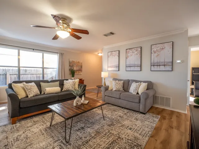 a living room with furniture and a large window