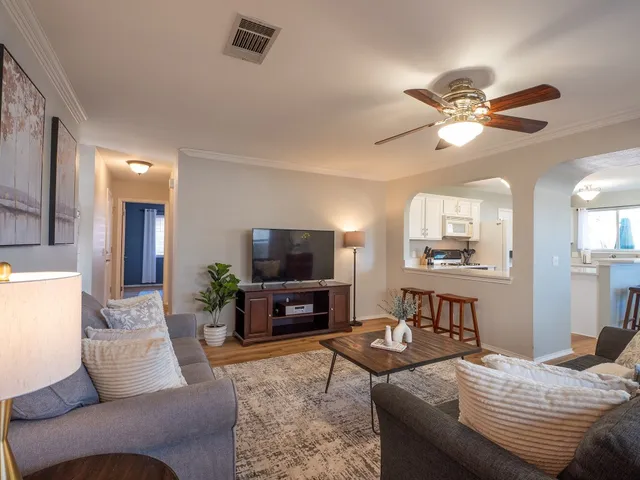 a living room with furniture and a flat screen tv