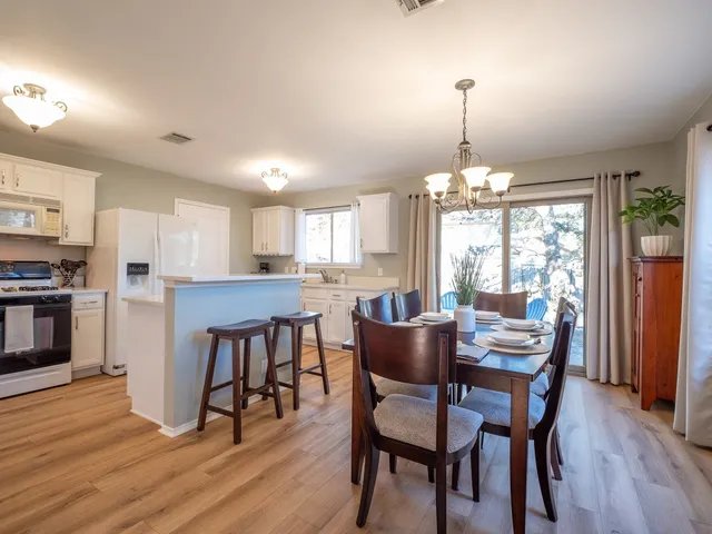 a dining room with furniture and wooden floor