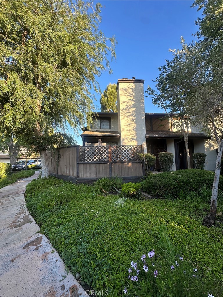 18223 Soledad Canyon Road, Unit 45 Canyon Country, CA 91387 - Photo 1 of 24 a front view of a house with a yard and a tree