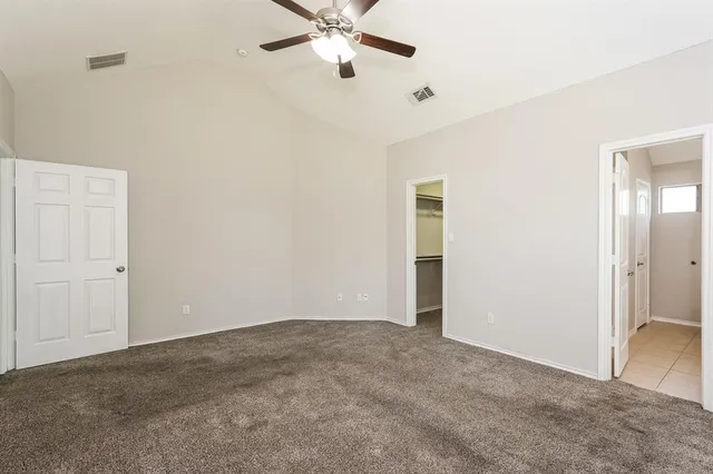 a view of an empty room with a ceiling fan