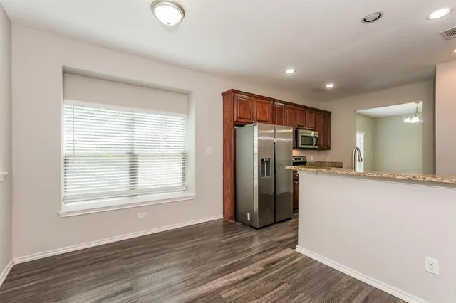 a view of a refrigerator in kitchen and wooden floor