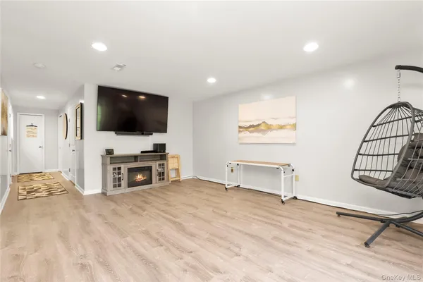 a view of a livingroom with furniture and a flat screen tv