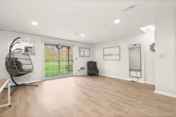 a view of a room with gym equipment and a large window