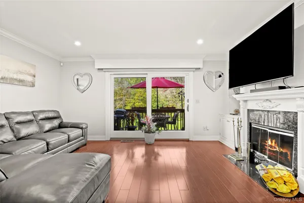 a living room with furniture a flat screen tv and a fireplace