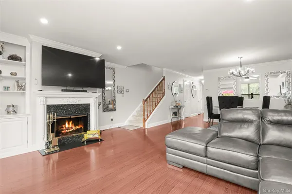 a living room with furniture a flat screen tv and a fireplace
