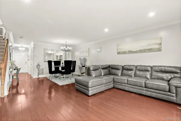 a living room with furniture a wooden floor and a fireplace
