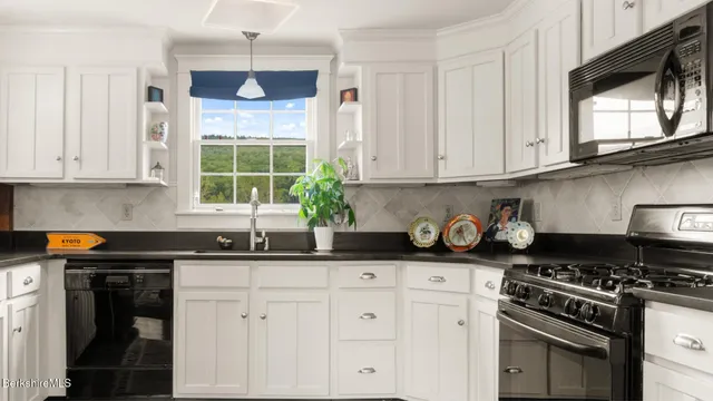 a living room with fireplace furniture and a large window