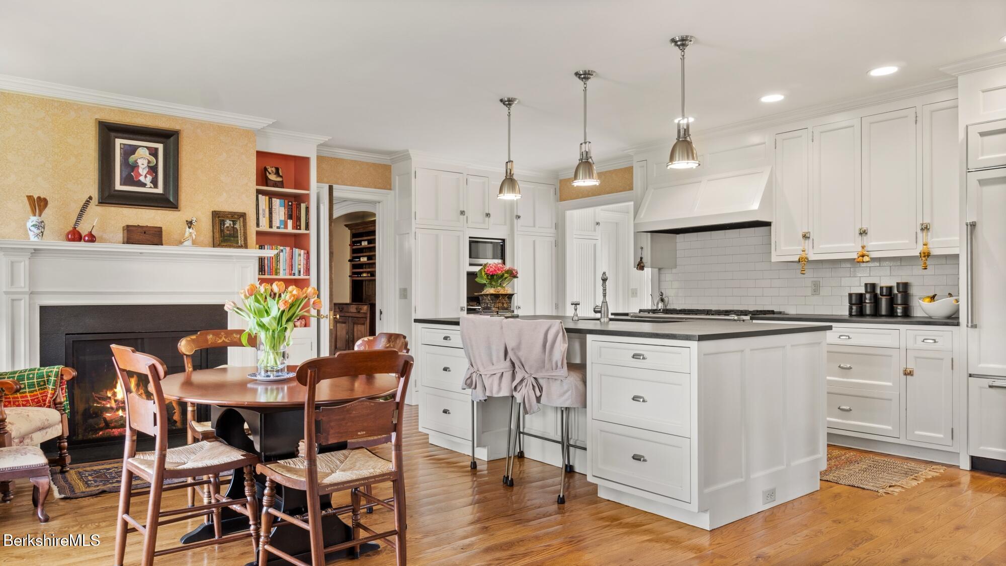 2650 Swamp Road Richmond, MA 01254 - Photo 5 of 49 a kitchen with white cabinets and chairs