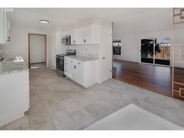 a view of a room with wooden floor and window