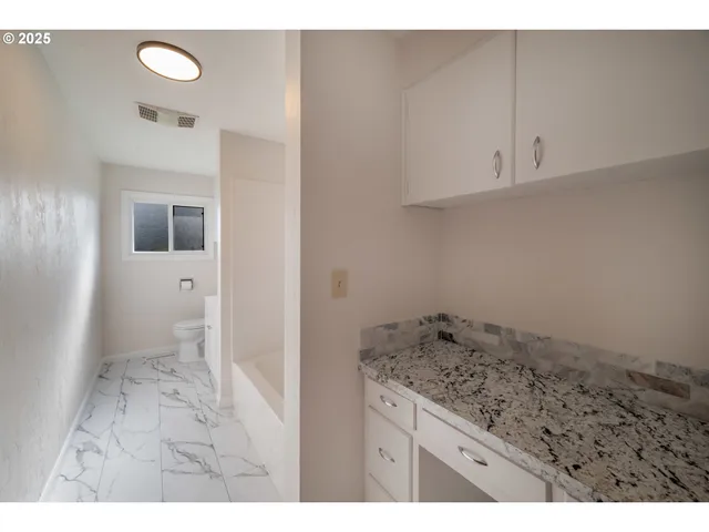 a bathroom with a sink mirror vanity and toilet