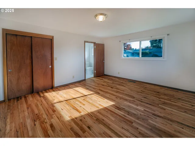 a view of an empty room and wooden floor