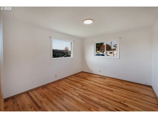 a view of an empty room and wooden floor