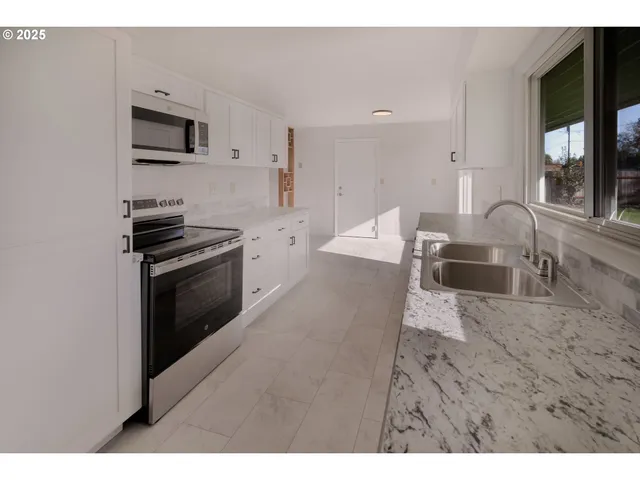 a en suite bathroom with a granite countertop sink and a mirror