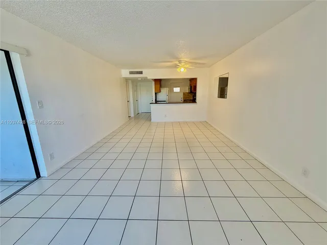 a view of an empty room and a window