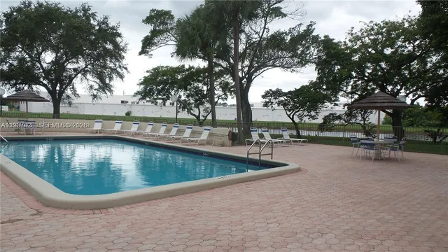 a view of a lake with a table and chairs