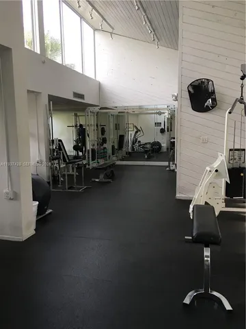 a room with gym equipment and windows