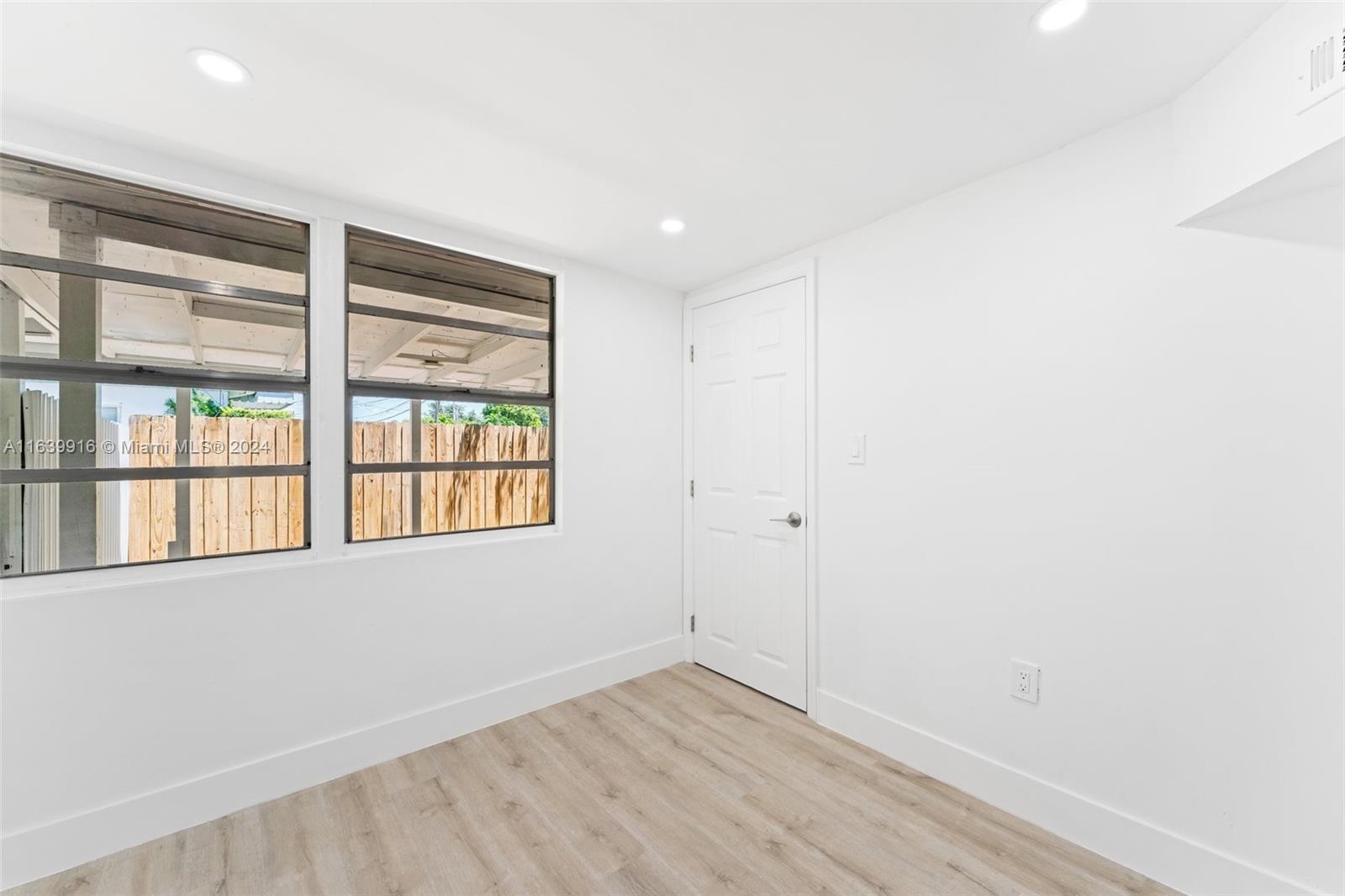3155 Southwest 27th Lane, Unit 1 Miami, FL 33133 - Photo 13 of 18 an empty room with a window