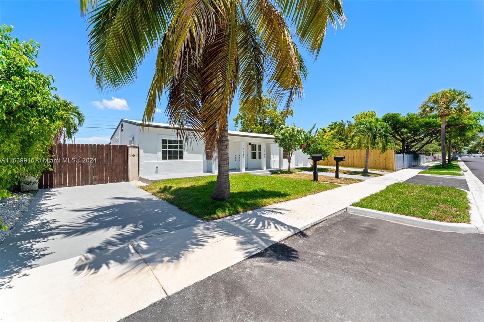 3155 Southwest 27th Lane, Unit 1 Miami, FL 33133 - Photo 2 of 18 a view of a backyard with palm trees