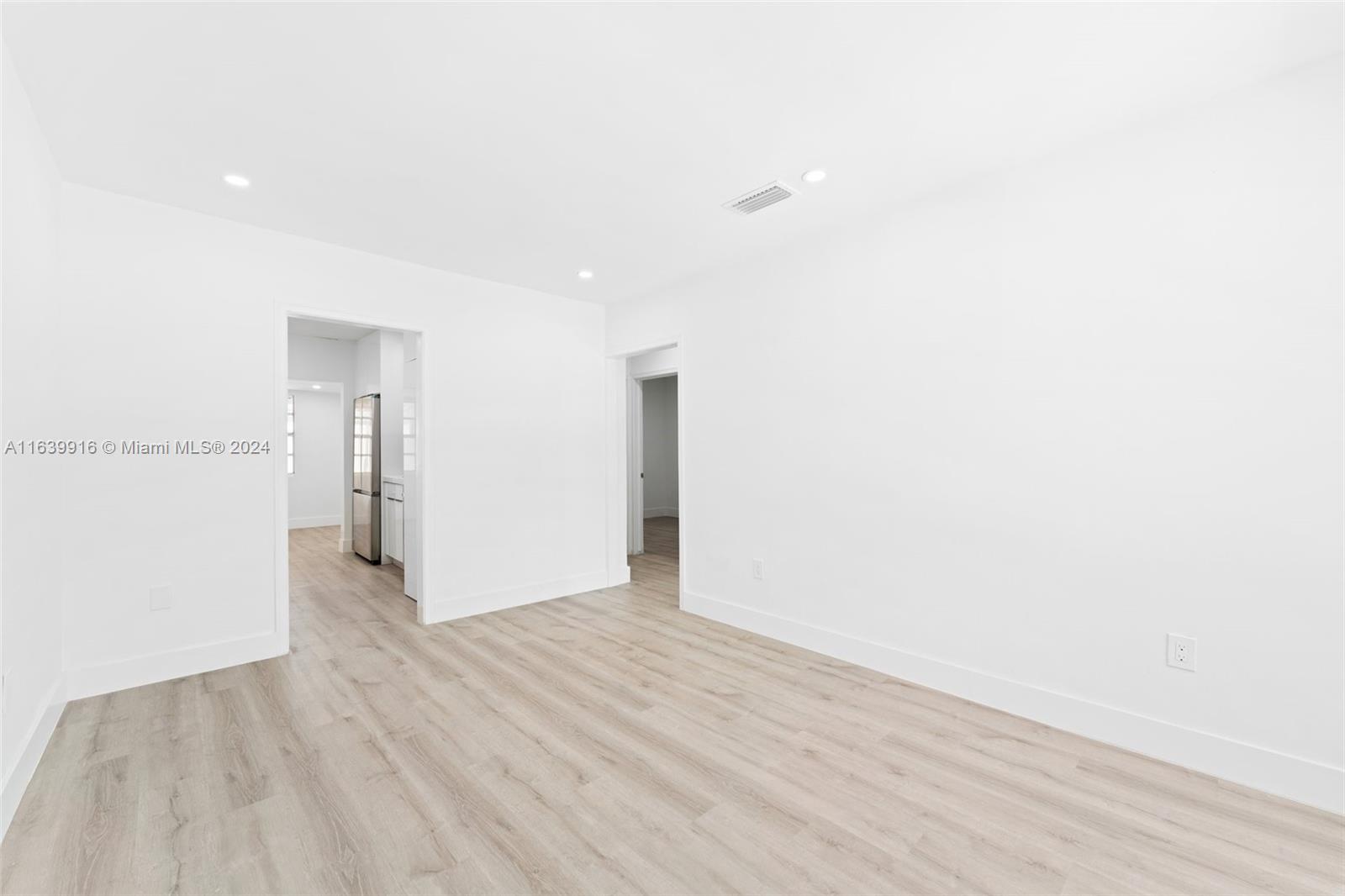 3155 Southwest 27th Lane, Unit 1 Miami, FL 33133 - Photo 5 of 18 a view of an empty room with wooden floor