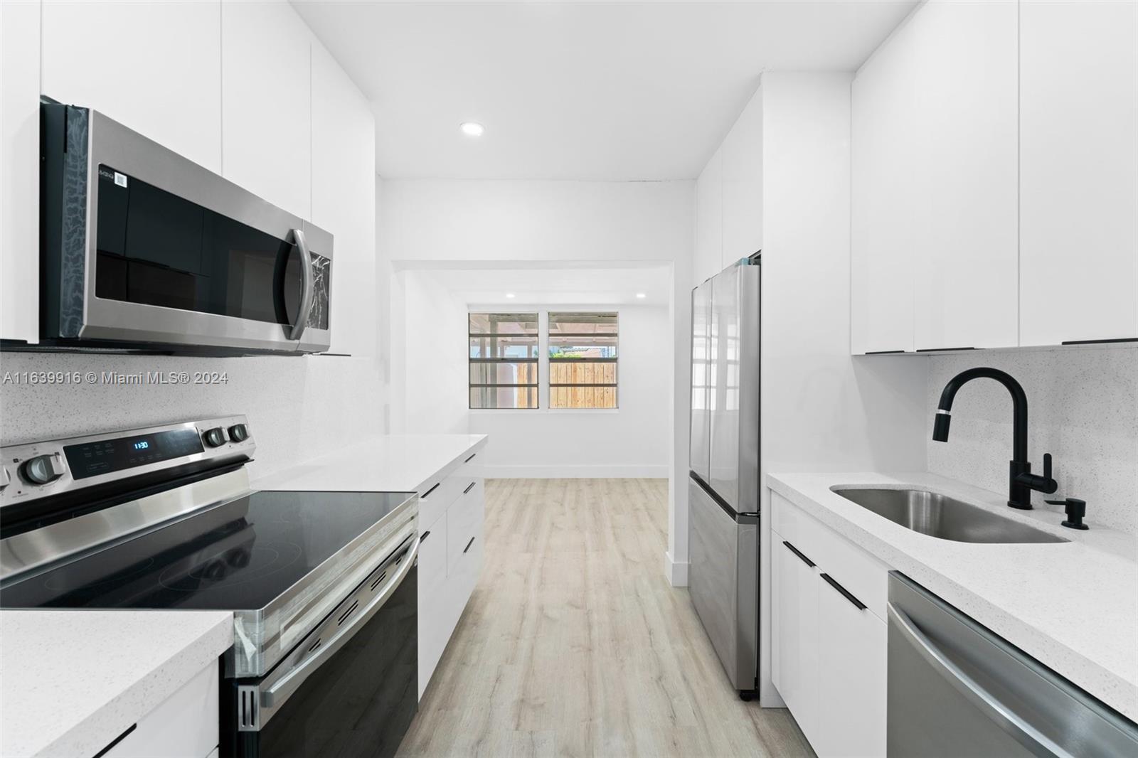 3155 Southwest 27th Lane, Unit 1 Miami, FL 33133 - Photo 7 of 18 a kitchen with a sink and steel appliances