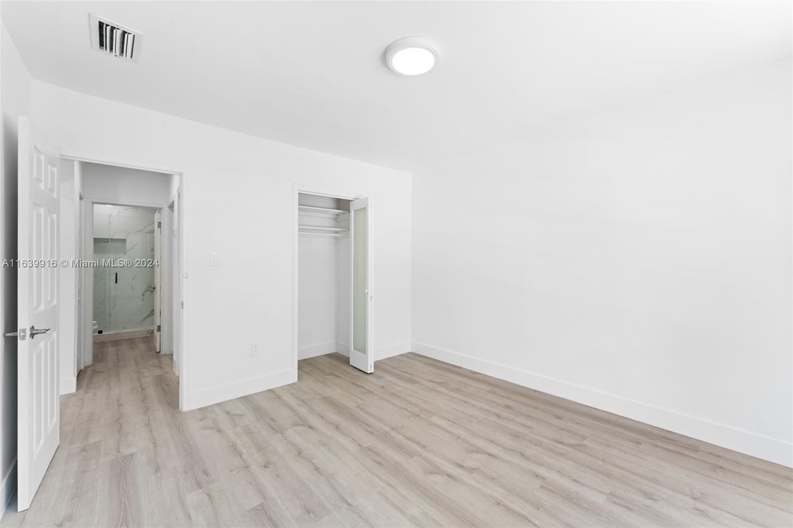 3155 Southwest 27th Lane, Unit 1 Miami, FL 33133 - Photo 10 of 18 a view of a room with wooden floor