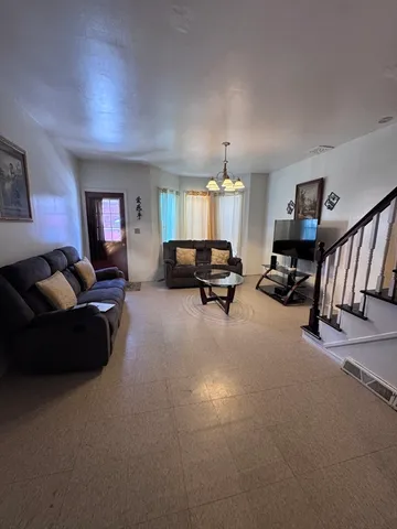 a living room with furniture gym and a window