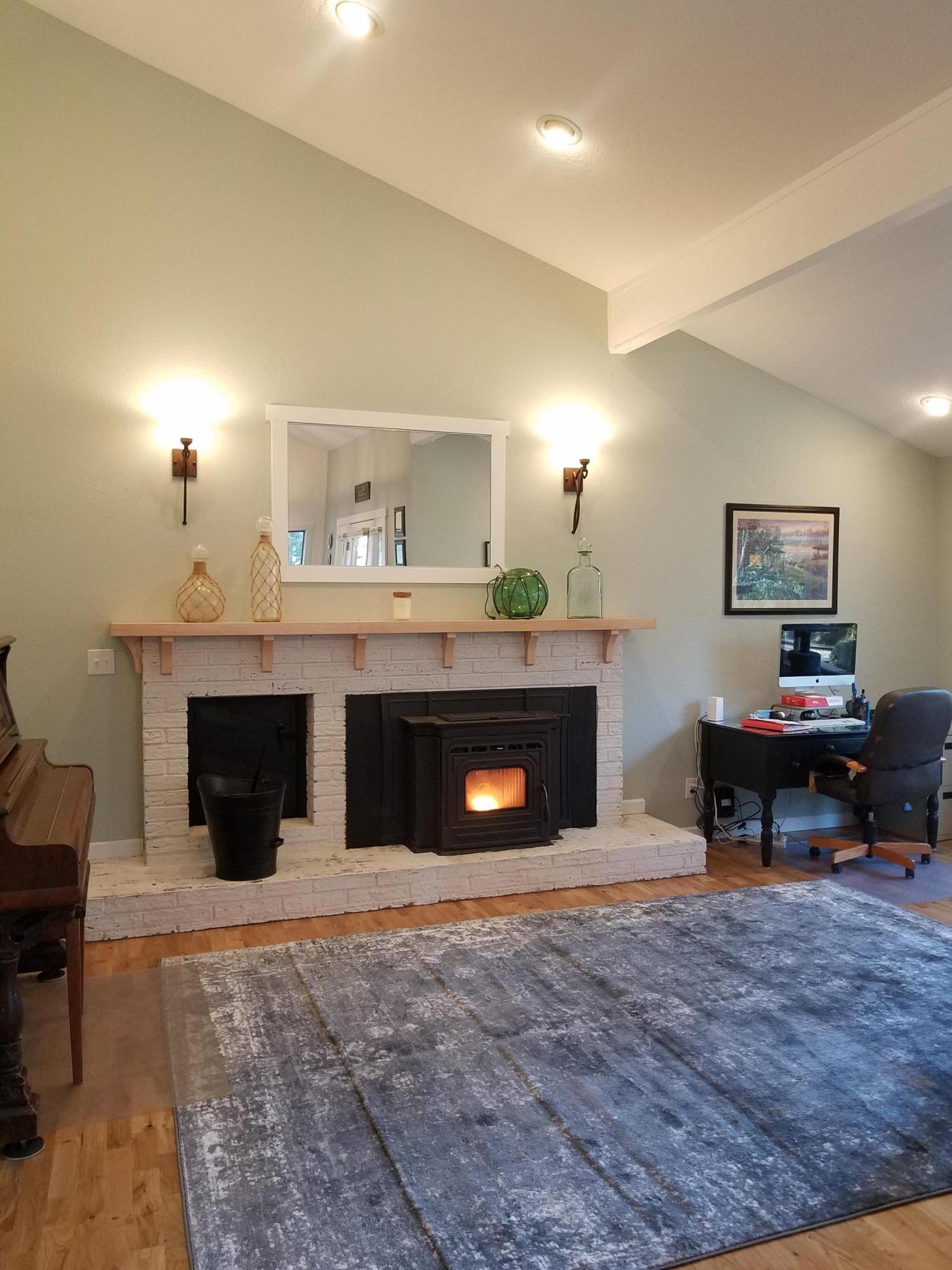 7837 Colonial Way Central Point, OR 97502 - Photo 9 of 25 a living room with furniture and a fireplace