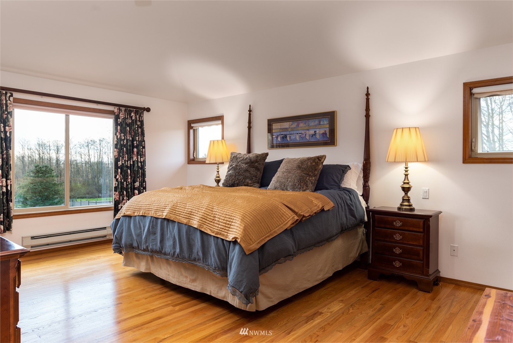 6187 Swanson Road Bow, WA 98232 - Photo 19 of 40 a spacious bedroom with a bed and wooden floor