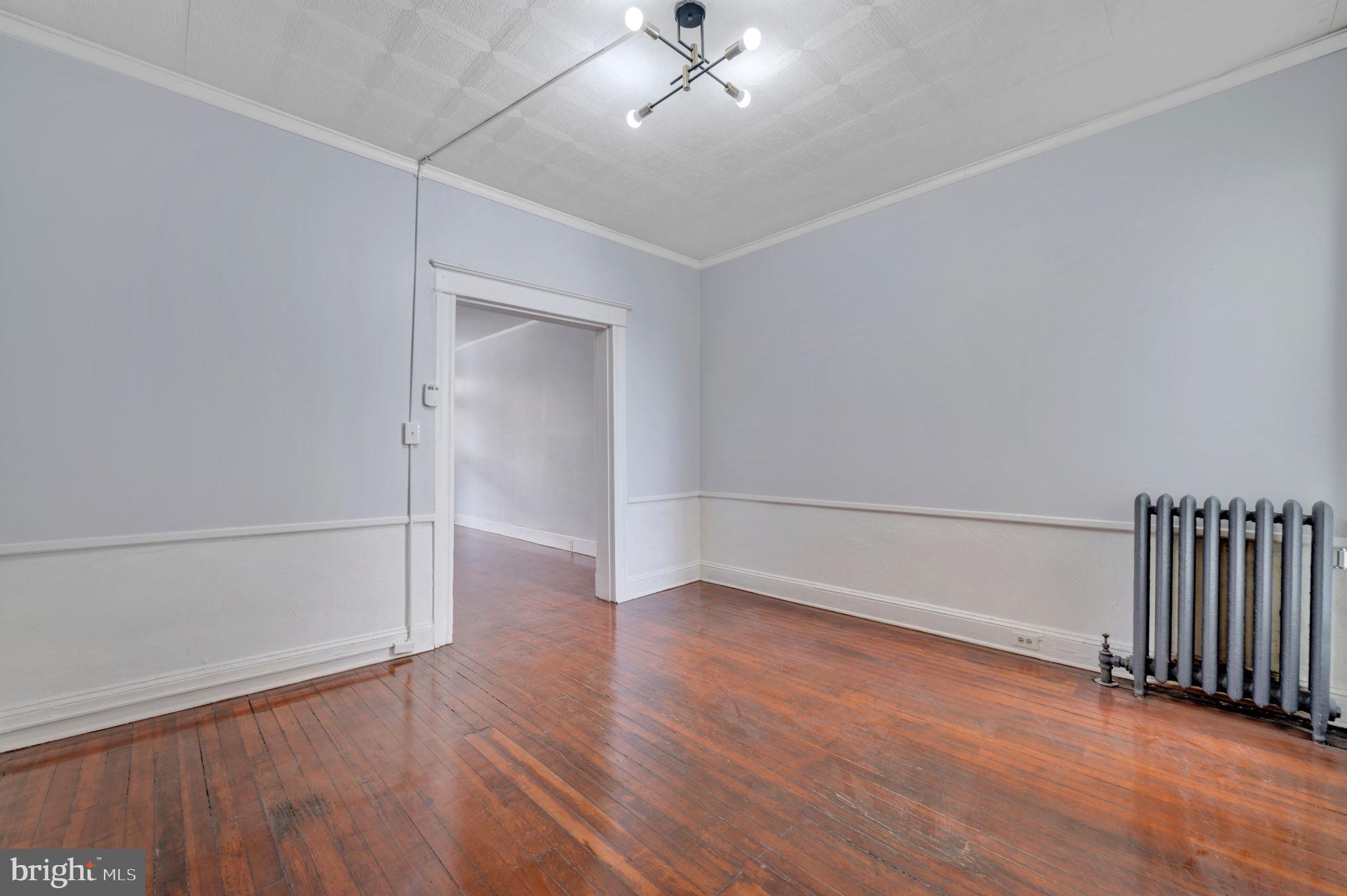 2822 Riggs Avenue Baltimore, MD 21216 - Photo 11 of 30 a view of an empty room with wooden floor