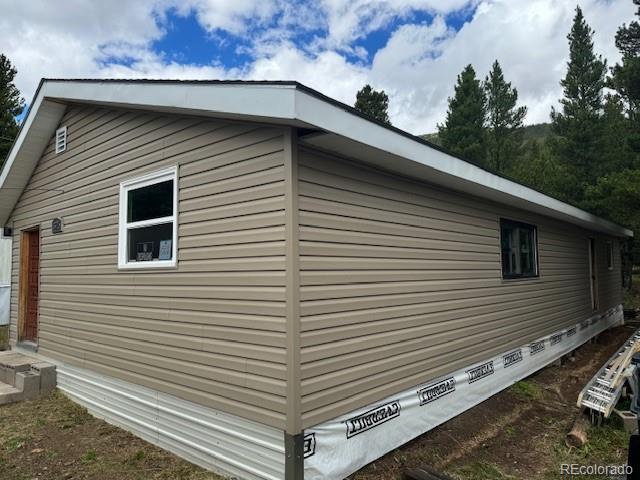 325 Aspen Road Idaho Springs, CO 80452 - Photo 3 of 12 a view of a back side of house