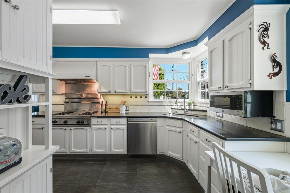 330 41st Avenue San Mateo, CA 94403 - Photo 15 of 38 a kitchen with stainless steel appliances granite countertop a sink stove and cabinets